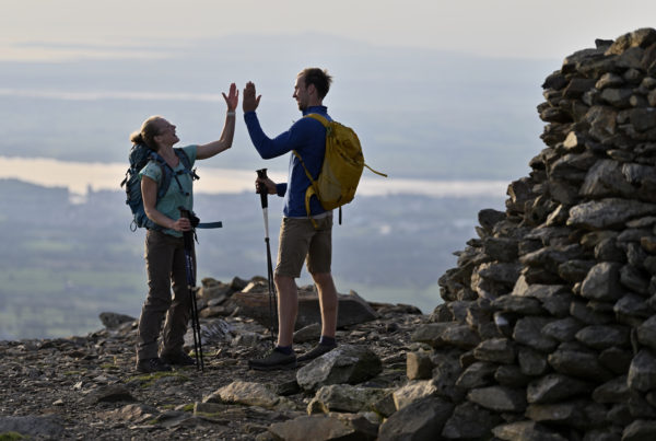 Couple celebrating reaching the summit of Moel Eilio