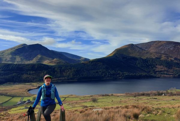 solo women on a stile out hiking/trail running