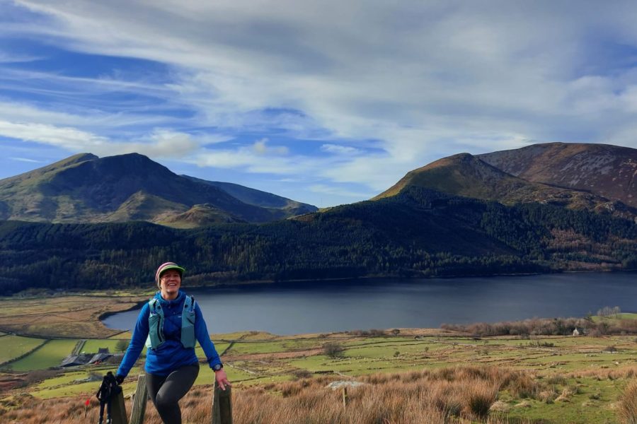 solo women on a stile out hiking/trail running